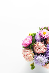 beautiful autumn bouquet of asters on a white background. simple flat composition with space for text, vertical frame