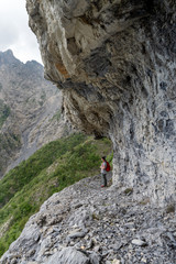 Female hiker on mountain pathway, Ligurian Alps, Italy