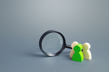 Figures of people stand near a magnifying glass. Search for jobs and vacancies. Human resources....