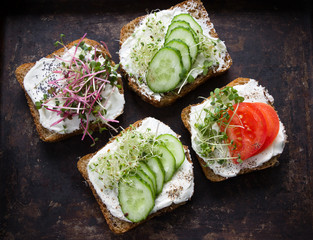 Healthy sandwiches with cream cheese , microgreens, tomatoes and cucumber. Healthy eating, diet food, vegan food, healthy breakfast