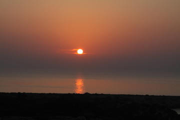 Obraz premium Orange beautiful sunrise on the sea. Relax vacation. Meet the sunrise on the seashore. Romantic coasline. Wallpaper and background.