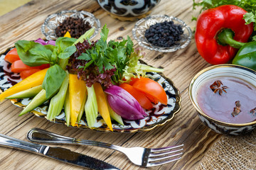Salad from tomatoes, cucumber, red onions and lettuce leaves. healthy summer vitamin menu. vegan vegetable food. vegetarian dinner table. top view. flat lay