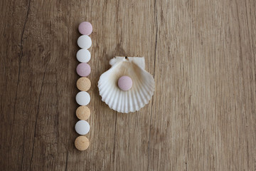 Tablets of calcium and shell on a wooden table. Medical concept. Minerals for health. Top view. vitamins