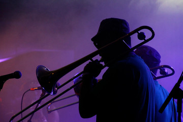 Jazz musicians performing in the French Quarter of New Orleans, Louisiana, with smoke and neon...