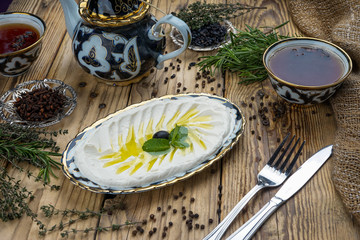 Chickpea hummus in bowl on wooden table