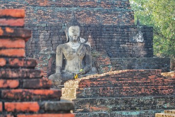 Ancient Buddha Statue of Mahathat Temple in the Sukhothai Historical Park, One of Thailand’s most impressive World Heritage sites. It is near the city of Sukhothai, THAILAND.