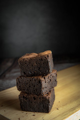brownies cut in squares. Dark food photography concept