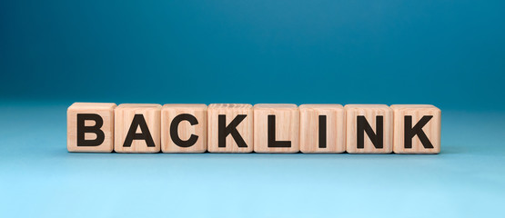 Backlink - text concept on wooden cubes with blue background