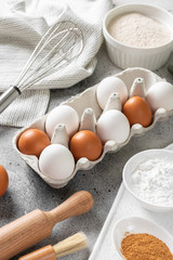 Ingredients for baking on a culinary background. Eggs, flour, cinnamon, sugar, soda on the kitchen table. Concept of preparation for baking