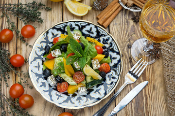 Salad from tomatoes, cucumber, red onions and lettuce leaves. healthy summer vitamin menu. vegan vegetable food. vegetarian dinner table. top view. flat lay