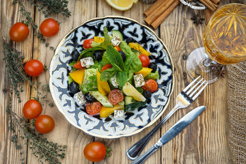 Salad from tomatoes, cucumber, red onions and lettuce leaves. healthy summer vitamin menu. vegan vegetable food. vegetarian dinner table. top view. flat lay
