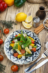 Salad from tomatoes, cucumber, red onions and lettuce leaves. healthy summer vitamin menu. vegan vegetable food. vegetarian dinner table. top view. flat lay