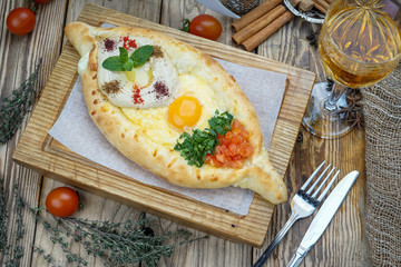 Freshly baked khachapuri. national georgian pastries with cheese and raw eggs