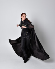 fantasy portrait of a woman with red hair wearing dark leather assassin costume with long black...