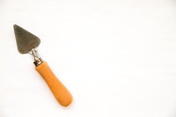 Construction trowel on a white background. Building tool. Metal part.