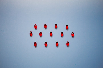 Vitamin e red capsules isolated on a blue background