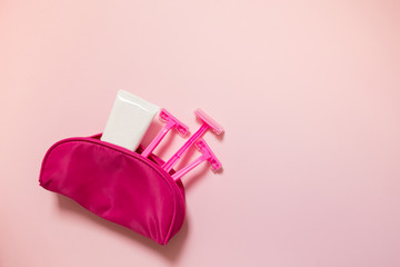 Twin pink blades razor and cream for a comfortable shaving for female on a pink background close-up