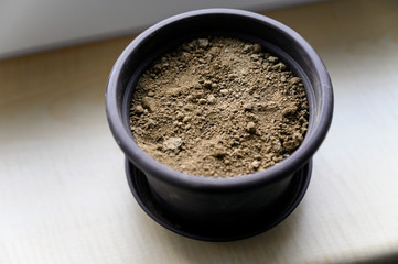 Close-up of clay in a pot on the windowsill.