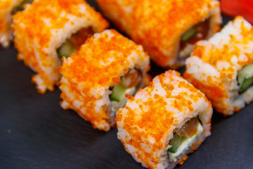 Sushi rolls Philadelphia on a black slate