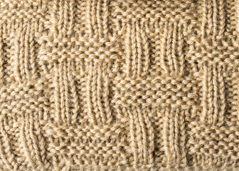 Knitted background. Knitted texture. A sample of knitting from wool. Knitting Pattern.