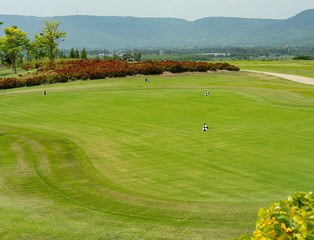 flags on the golf course green in mountain