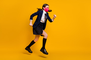 Fototapeta na wymiar Full length body size view of her she nice attractive purposeful focused schoolgirl jumping wearing mask running fast hurry rush isolated over bright vivid shine vibrant yellow color background
