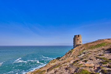Fototapeta na wymiar Image of German WW2 bunker and gun emplacement on the North West coast early sunny morning with blue sky, Jersey, Channel Islands, uk