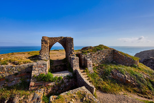 Image of Grosnez Castle keep constructed circa 1330 and located in the North West corner of Jersey early morning with the sea in the background and blue skys.  Jersey, Channel Islands, UK