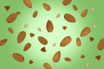 Falling almonds isolated on a colored background with clipping path as package design element and advertising. Flying food. Top view.