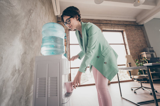 Profile side photo of lovely charming representative lawyer have office hot temperature want drink fill cold water mug from cooler wear pink stylish pants trousers in workforce