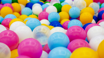 Closeup abstract photo of colorful plastic ball in pit on the playground at shopping mall
