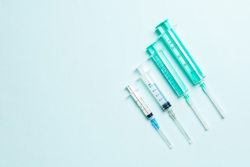 Top view of syringes in a row for medical injection on colorful background with copy space. Health...
