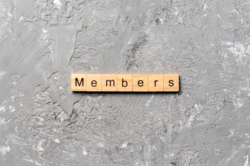 Members word written on wood block. Members text on cement table for your desing, concept