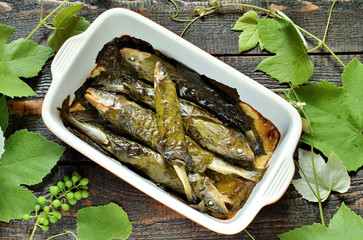 small fish in grape leaves baked as dolma. Mediterranean dish. popular in Greece and Turkey. Fish...
