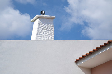 White chimney with wall and roof