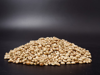 raw not roasted coffee beans from africa on a dark background
