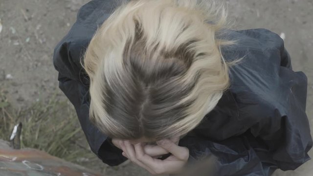 Top view of praying young blond man. Stock footage. Young adult man begging and praying with hope and his hands together by his heart and then raises his hands in the air.