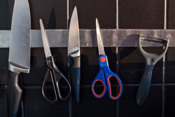 Kitchenware and scissors on the magnetic line