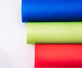 Rolls of colored paper on a white background