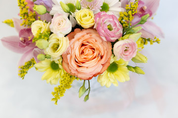 Obraz na płótnie Canvas A magnificent bouquet of fresh flowers on a light background (Colors: white, pink, yellow, green. Flowers: rose, eustoma, chrysanthemum, orchid, snapdragon)