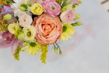 A magnificent bouquet of fresh flowers on a light background (Colors: white, pink, yellow, green. Flowers: rose, eustoma, chrysanthemum, orchid, snapdragon)