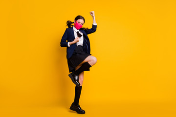 Fototapeta na wymiar Full length body size view of her she nice attractive lucky schoolgirl jumping rejoicing accomplishment attainment wearing mask isolated over bright vivid shine vibrant yellow color background
