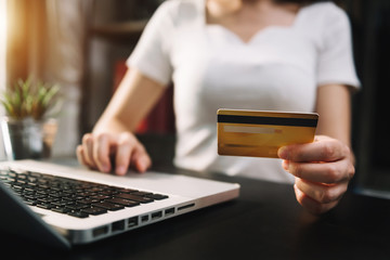 Business woman hands using smartphone and holding credit card with digital layer effect diagram as Online shopping concept
