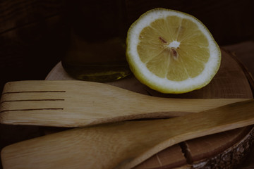 wooden spoon with lemon on a dark background