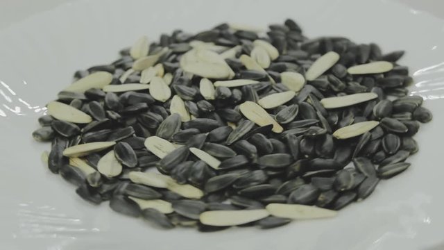 Rotation of a pile of black and white sunflower seeds. Organic food