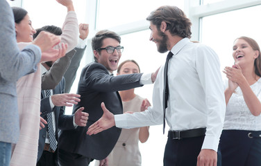 corporate group of employees congratulating each other on the victory