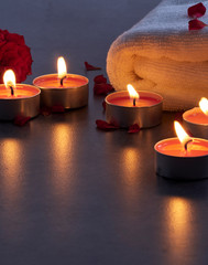 Spa composition of candles and rose.