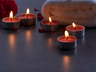 Spa composition of candles and rose.