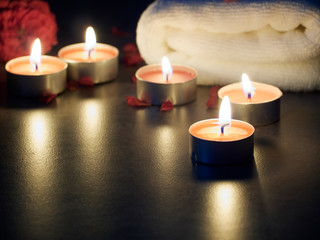 Spa composition of candles and rose.