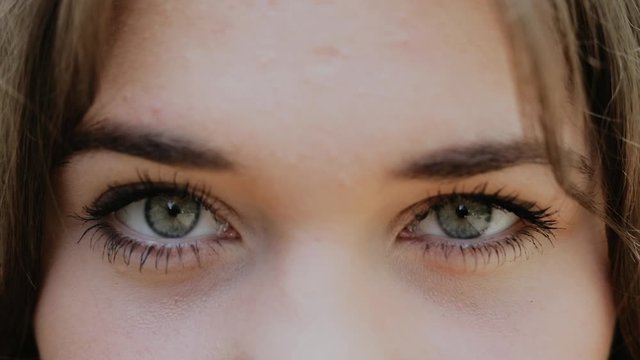 A close up portrait of beauty young beautiful womans eyes, looking at camera. 4 k. grey eyes of woman face, beautiful woman girl female portrait model, The girls eye. opening her grey eyes